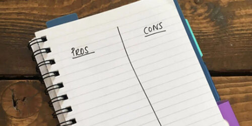 A pros and cons list written in a notebook