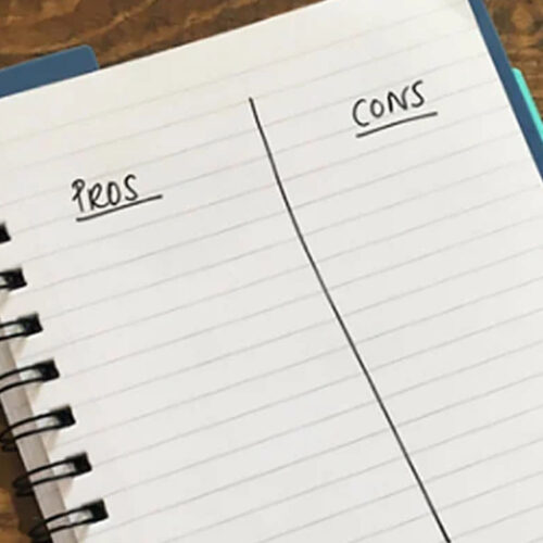 A pros and cons list written in a notebook