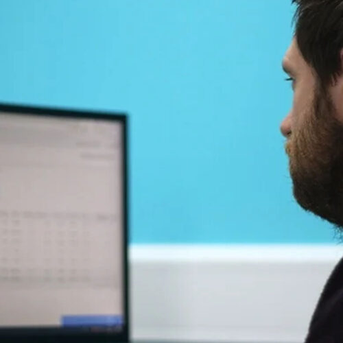A man looking at a computer screen