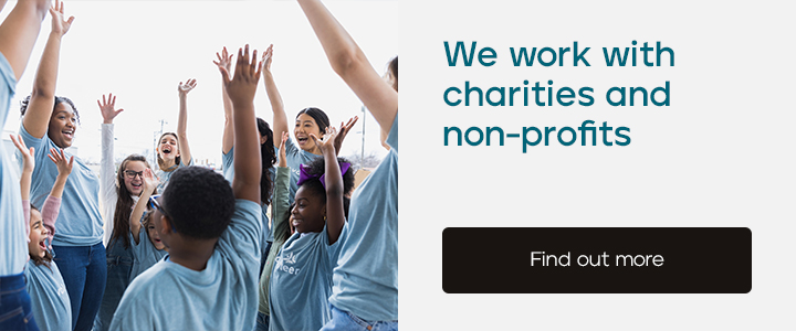 A banner with the text 'We work with charities and non-profits' and an image of lots of children with their arms in the air