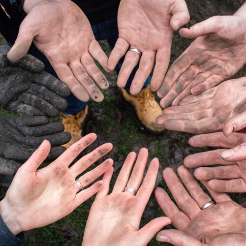 dirty hands in a circle with palms up