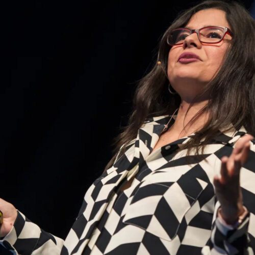 A woman on stage giving a talk