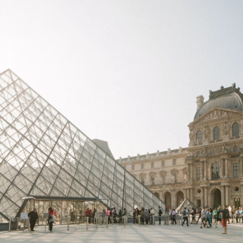 An image of the Louvre, a large glass pyramid