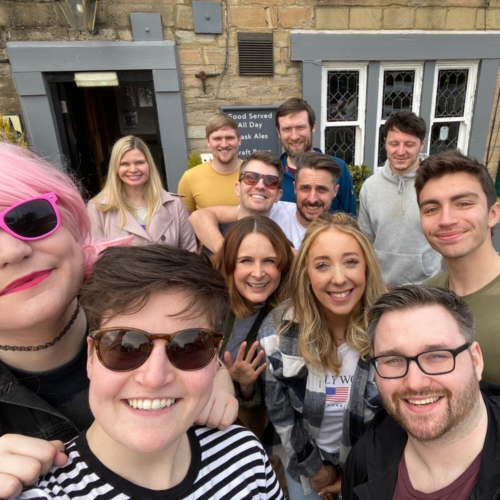 A team photo outside a restaurant