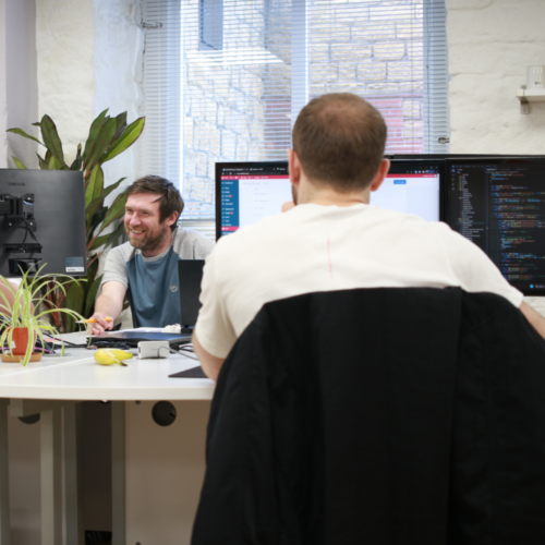 Greg smiling at a computer