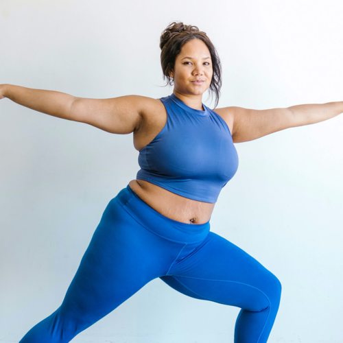 A person in a blue gym set doing a yoga pose