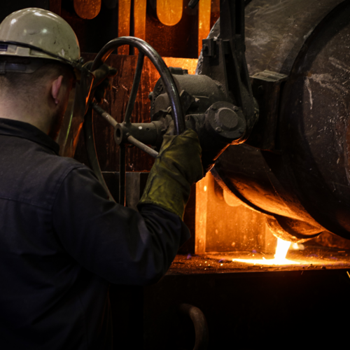 A person pouring molten metal