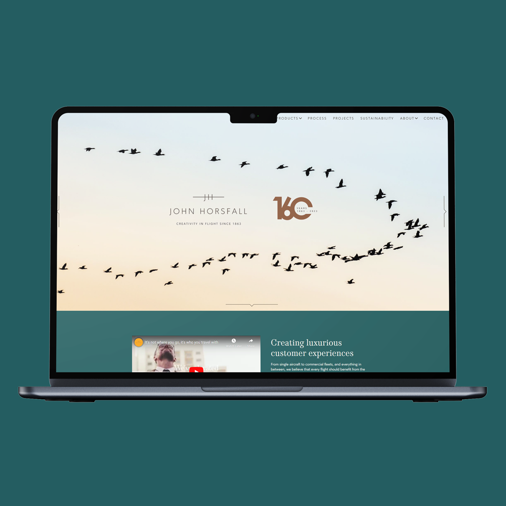 John Horsfall logo with a flock of birds shown on a laptop