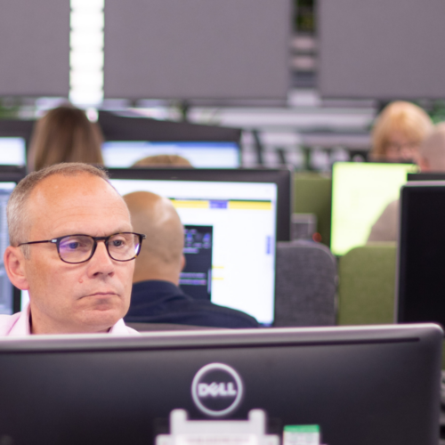 A man looking over a computer screen