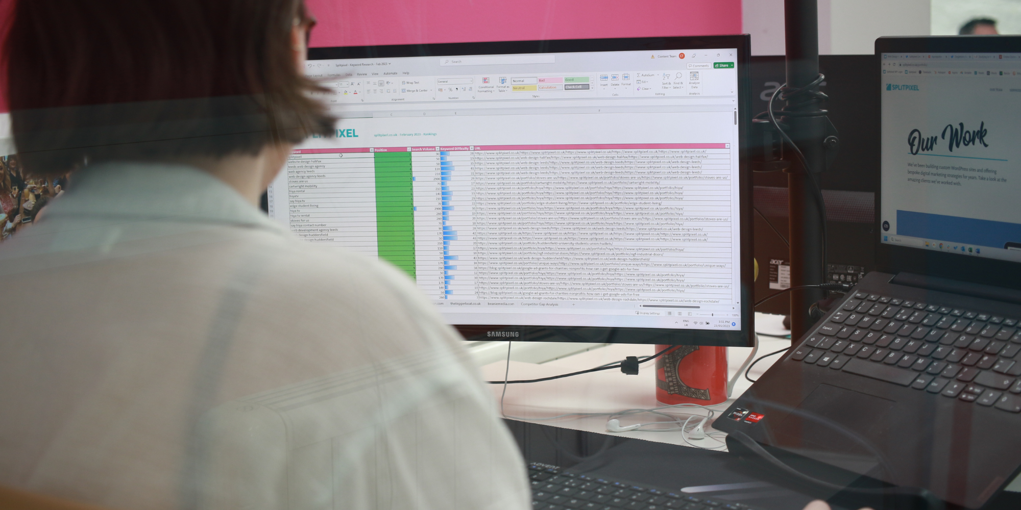 A computer screen showing a Splitpixel spreadsheet with a person looking at it