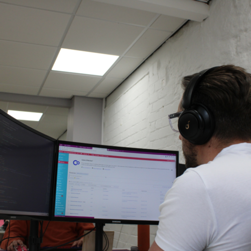 A person looking at two computer screens