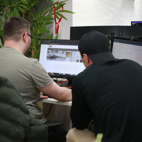 Two men looking at a computer screen showing the YSF homepage