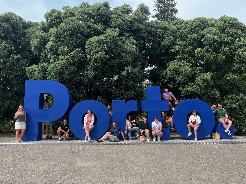 Splitpixel employees on a sign that says Porto.