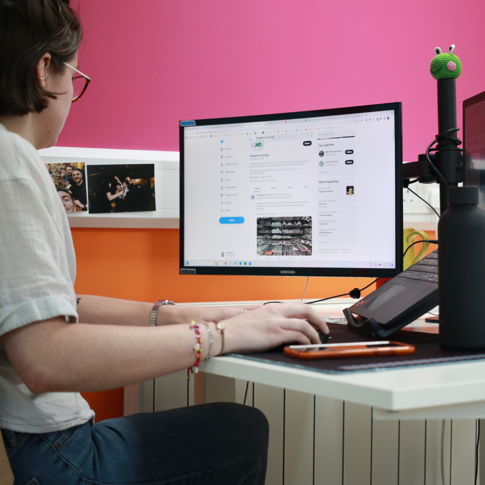 Image of a person sat at a desk working on a computer