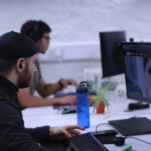 Two men looking at computer screens in an office