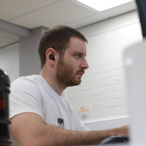 Tom working on a computer