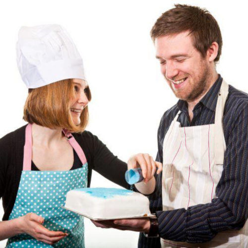 Charlie and Greg decorating a cake together