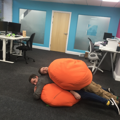 Rob and Job in the office on the floor with beanbags