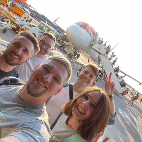 A selfie of Charlie, Ash, Jon, Rob and Seth getting on a plane