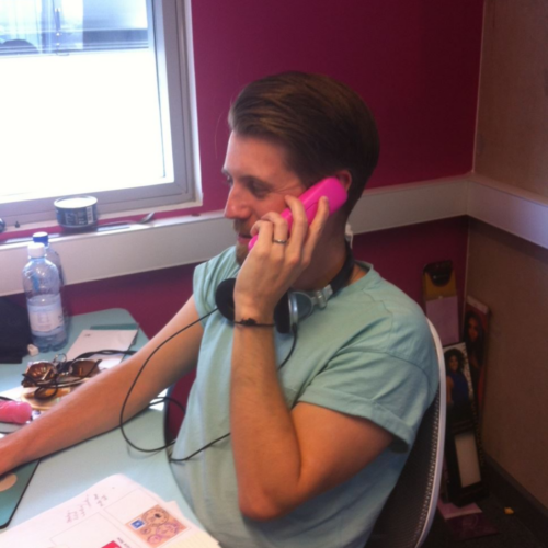 Rob answering a pink phone in the office